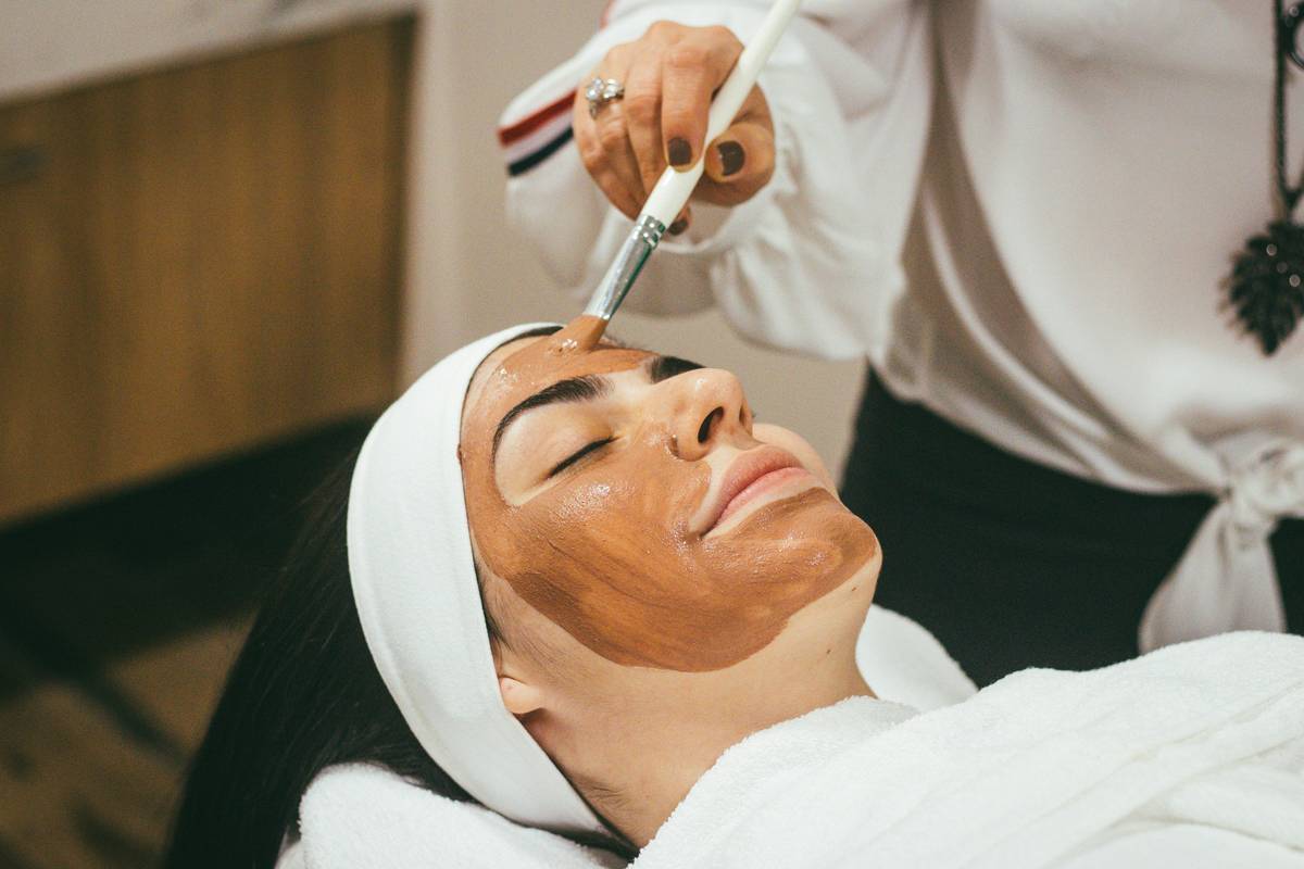 woman applying skin better science pads to clean skin