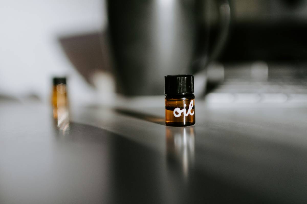 A discreet fragrance scented pad office solution health placed near a desk plant and laptop, emitting a subtle aroma without overwhelming the space.
